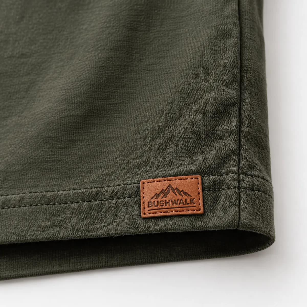 A Bushwalk leather label stitched onto a T-shirt hem